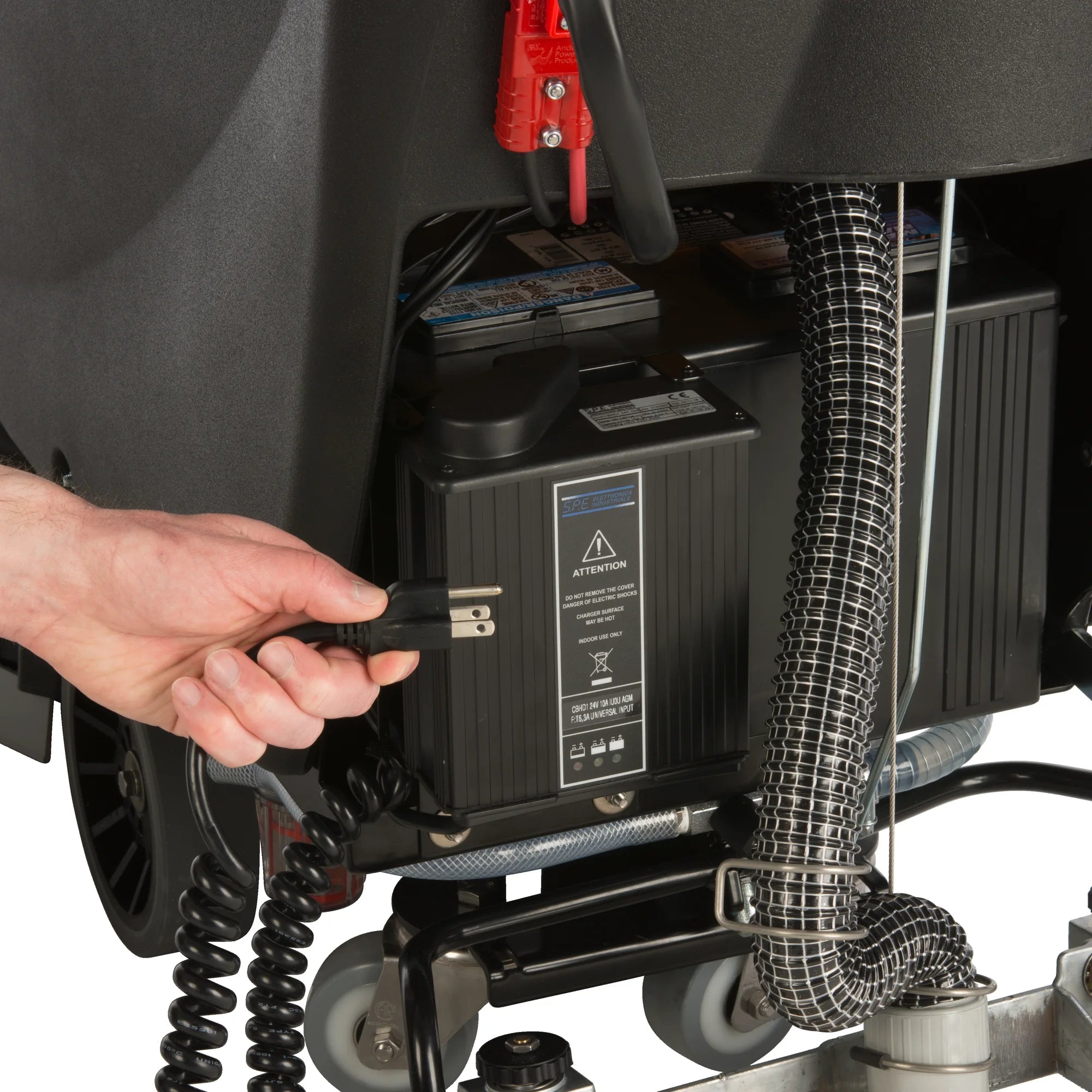 Plugging in the onboard charger on the Tornado BD 20/11LT traction-drive walk-behind scrubber
