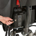 Plugging in the onboard charger on the Tornado BD 20/11LT traction-drive walk-behind scrubber
