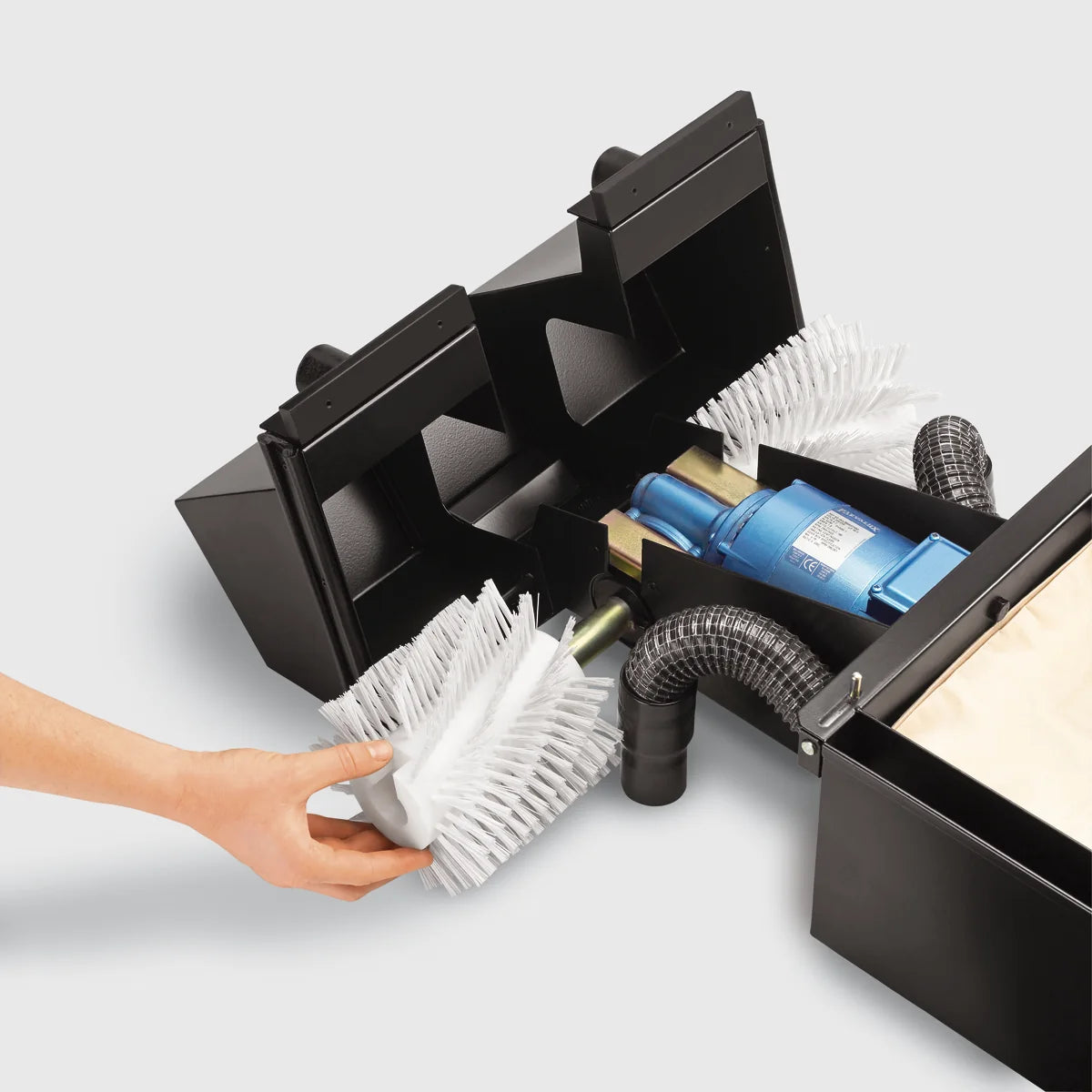 Hand sliding a brush onto the spindle of a Tornado BR 460 with the cover and brush cowl open, standard white nylon brush shown