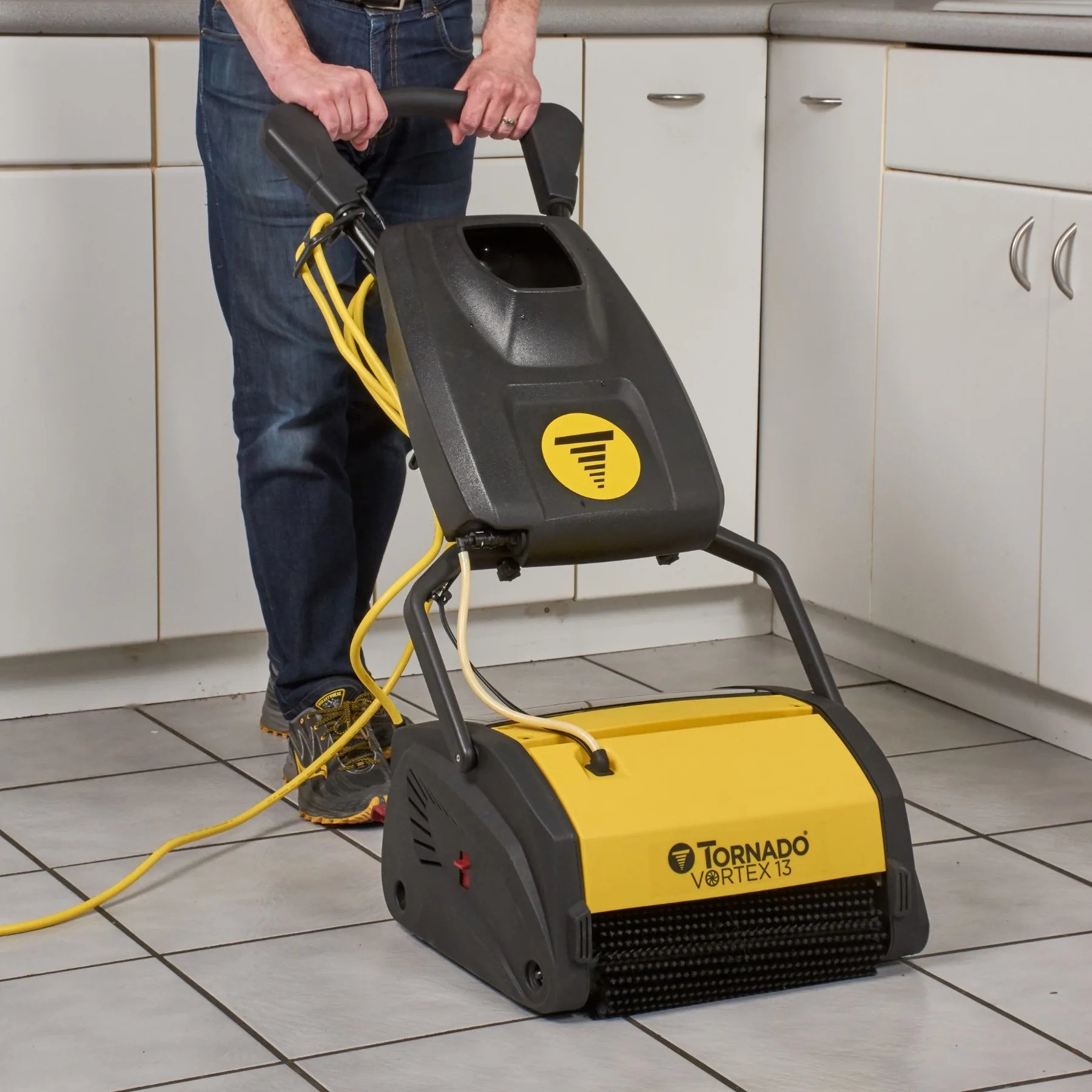 Tornado Vortex 13 CRB scrubber in use on commercial kitchen tile and grout floor