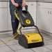 Tornado Vortex 13 CRB scrubber in use on commercial kitchen tile and grout floor