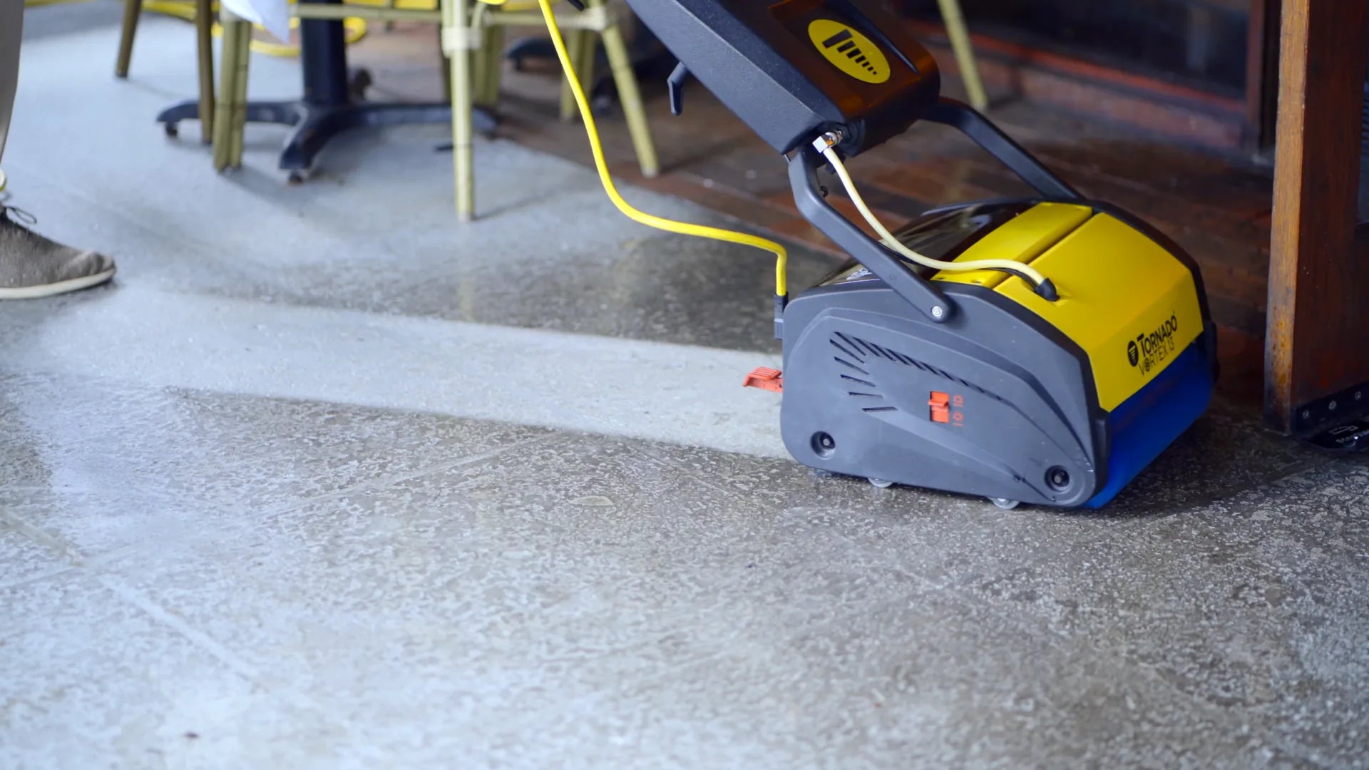 Tornado Vortex 18 CRB scrubber cleaning a greased patio floor showing a clear clean path.