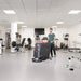 Viper AS5160 walk-behind scrubber cleaning the floor of a fitness center between weight machines