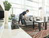 Operator cleaning a lobby sofa with the hose and hand tool of a Viper CEX410 carpet extractor